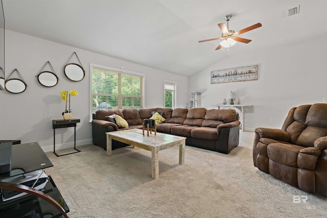 carpeted living area with a ceiling fan, vaulted ceiling, and baseboards