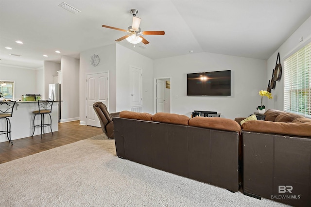 carpeted living room with ceiling fan, vaulted ceiling, recessed lighting, and wood finished floors