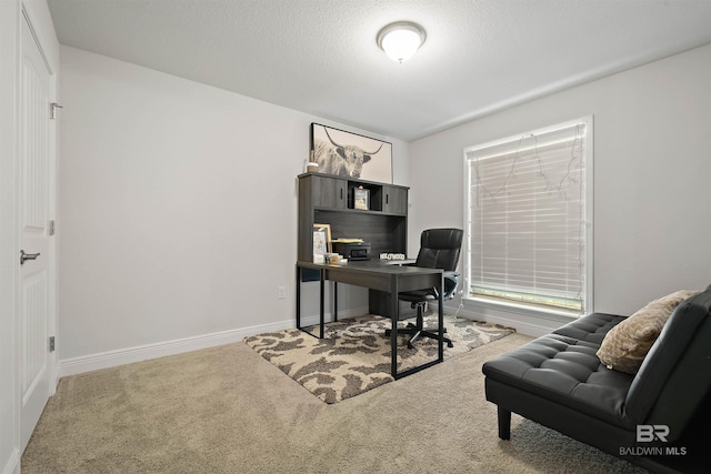 carpeted home office with baseboards