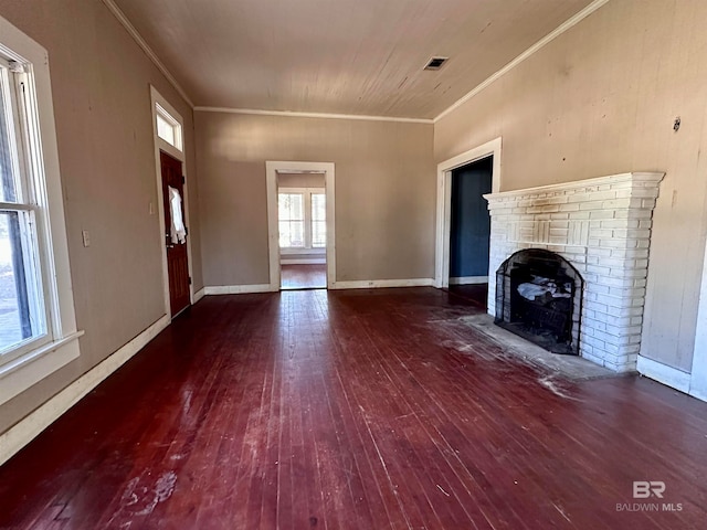 unfurnished living room with dark wood-type flooring, crown molding, and a fireplace