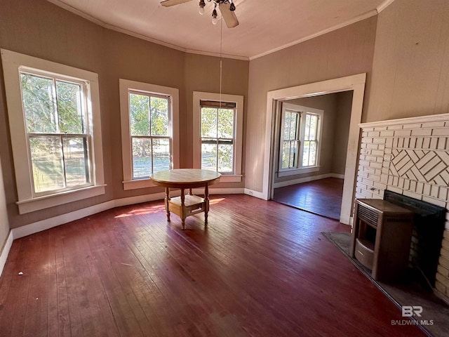 interior space with a wealth of natural light, dark wood-type flooring, and crown molding