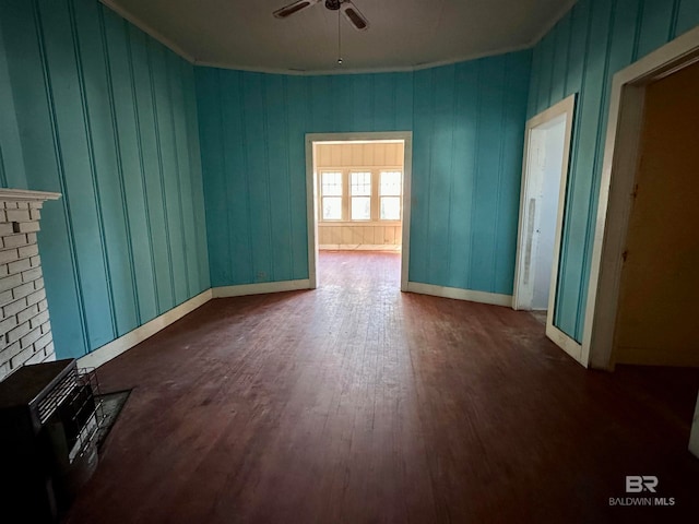 unfurnished room with crown molding, dark hardwood / wood-style flooring, and ceiling fan