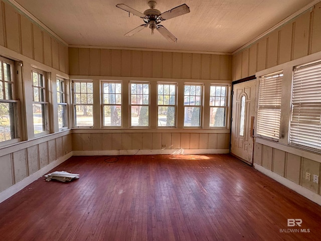 unfurnished sunroom with ceiling fan