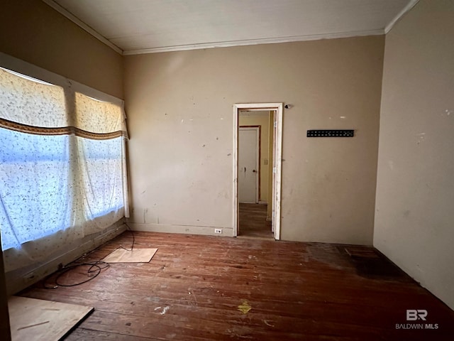 unfurnished room with crown molding and hardwood / wood-style floors