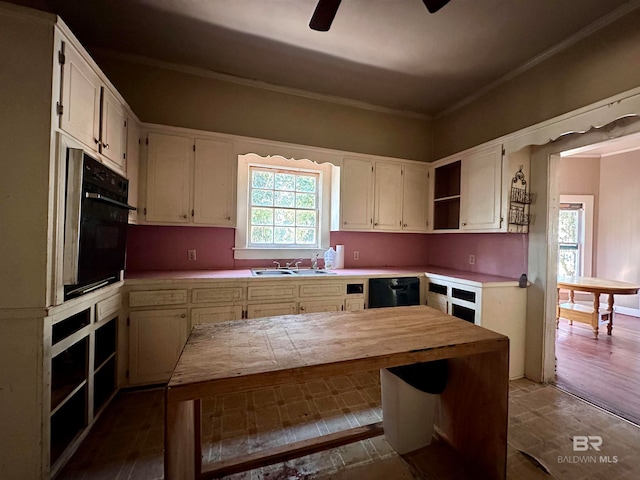 kitchen with black appliances, sink, ceiling fan, crown molding, and dark hardwood / wood-style floors