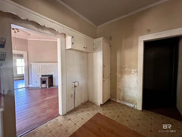 interior space with crown molding and light wood-type flooring