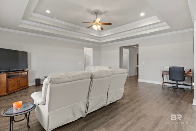 living room featuring a tray ceiling, crown molding, and hardwood / wood-style floors