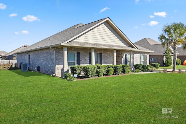 view of front of house featuring cooling unit and a front yard