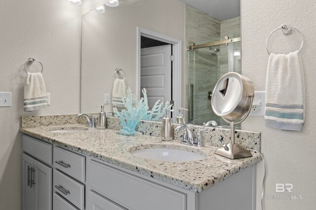 bathroom featuring vanity and a shower with shower door