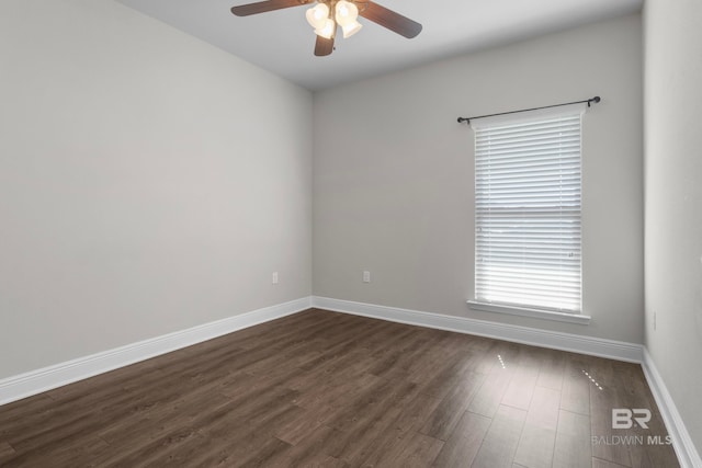 empty room with ceiling fan and dark wood-type flooring