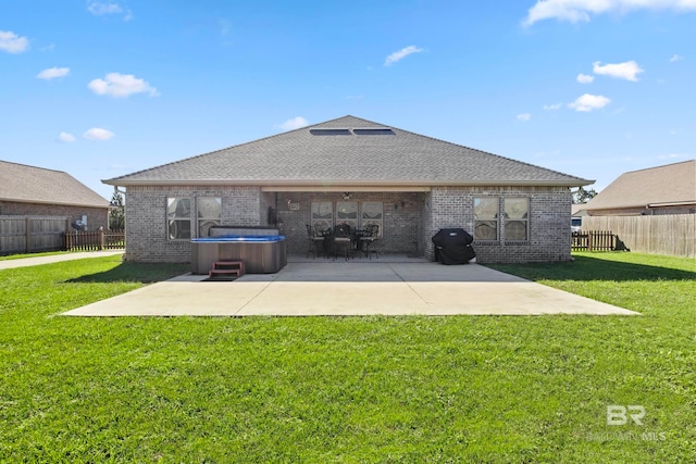 rear view of property featuring a patio area and a yard