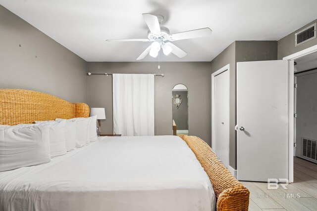 bedroom featuring ceiling fan, a closet, and light hardwood / wood-style floors