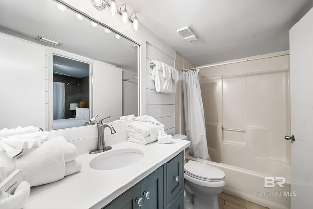 full bathroom featuring tile patterned flooring, vanity, shower / bath combo, and toilet