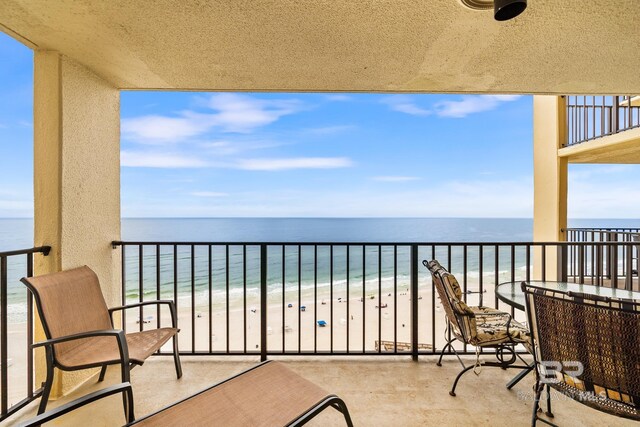 balcony with a water view and a beach view