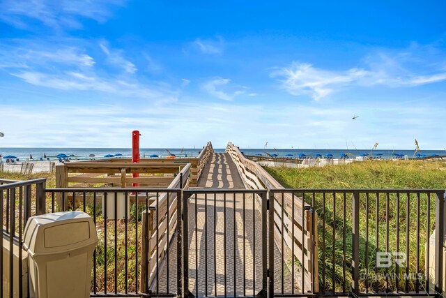 exterior space featuring a water view and a view of the beach