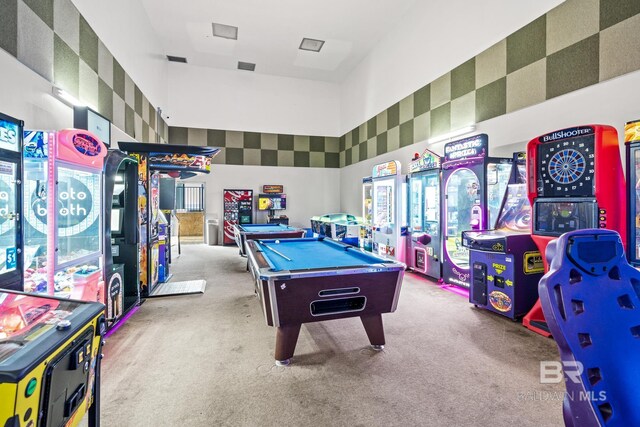 rec room featuring a towering ceiling, light colored carpet, and pool table