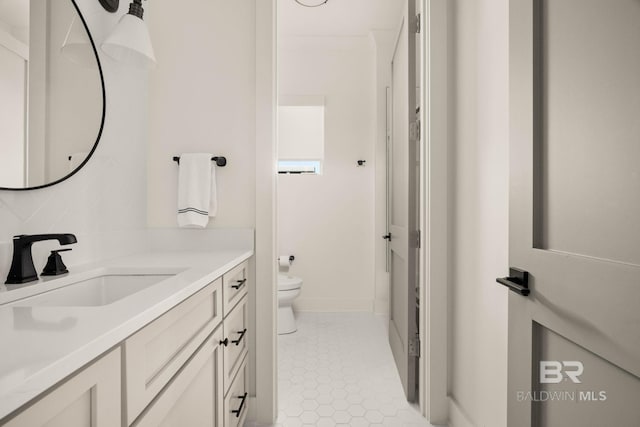 bathroom featuring tile patterned floors, vanity, and toilet