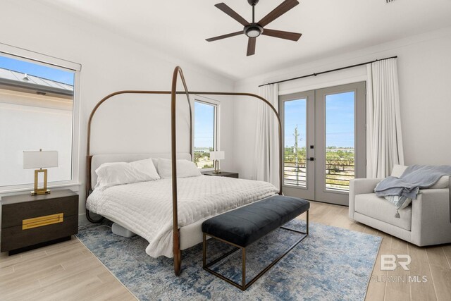 bedroom featuring light hardwood / wood-style flooring, ceiling fan, access to outside, and french doors