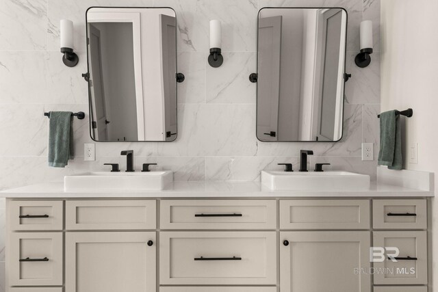 bathroom featuring tile walls, tasteful backsplash, and vanity