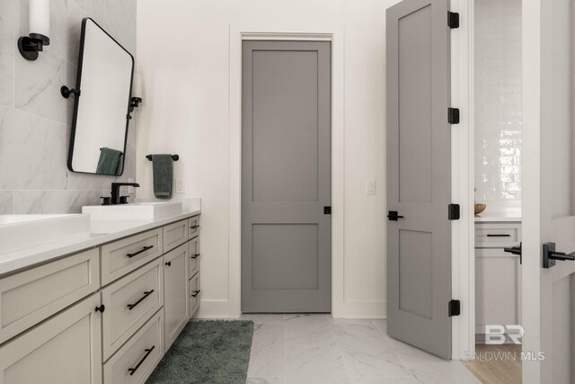 bathroom featuring tile patterned floors, vanity, and tile walls