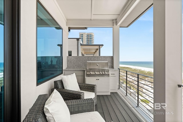 balcony featuring grilling area and a water view