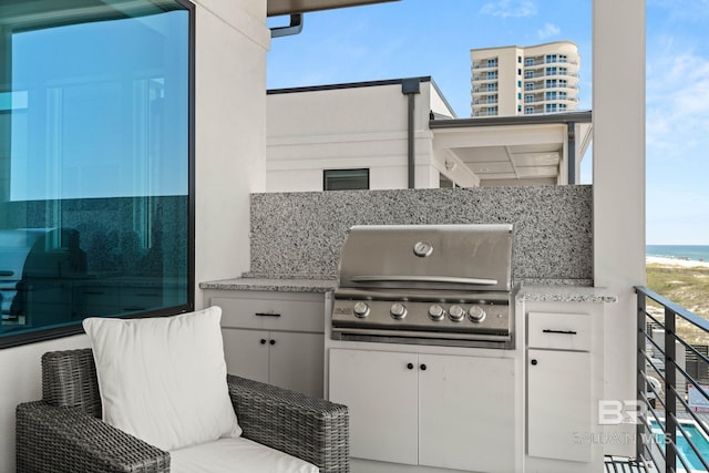 view of patio with a balcony, area for grilling, and an outdoor kitchen