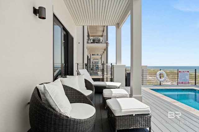 balcony with a community pool and a water view