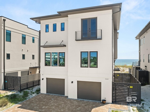 contemporary home with a garage and a water view