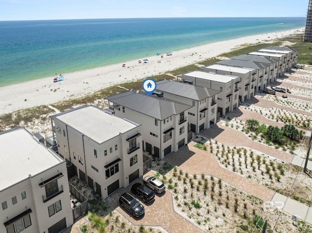 drone / aerial view featuring a beach view and a water view