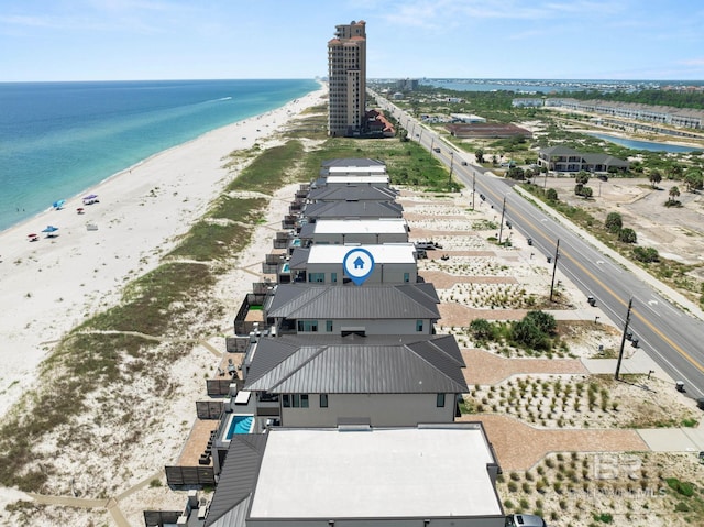 drone / aerial view with a beach view and a water view