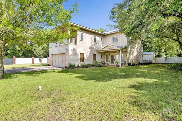 17541 Council Oaks Ln, Bon Secour, AL 36511 - view of front of home featuring driveway, board and batten siding, an attached garage, french doors, and a balcony