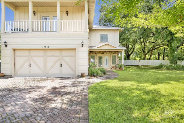 17541 Council Oaks Ln, Bon Secour, AL 36511 - front of property with french doors, a garage, and decorative driveway