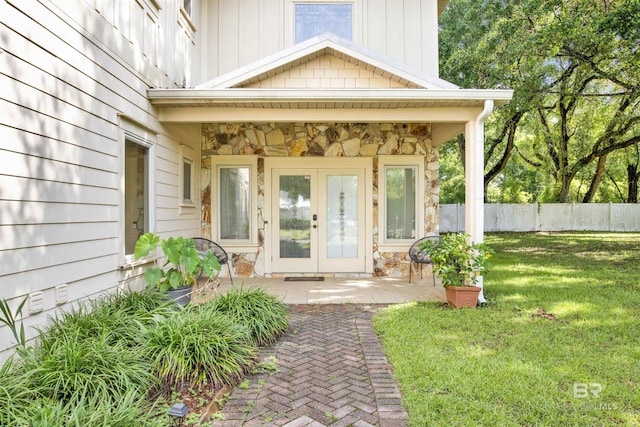 17541 Council Oaks Ln, Bon Secour, AL 36511 - view of exterior entry featuring stone siding, french doors, and board and batten siding