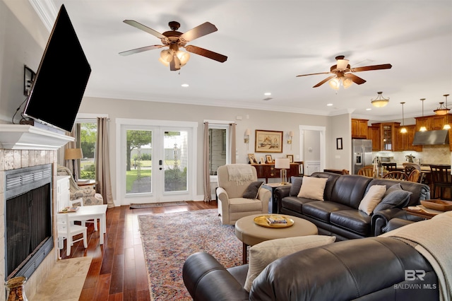 17541 Council Oaks Ln, Bon Secour, AL 36511 - living area with ceiling fan, dark wood-style flooring, a tiled fireplace, recessed lighting, and ornamental molding