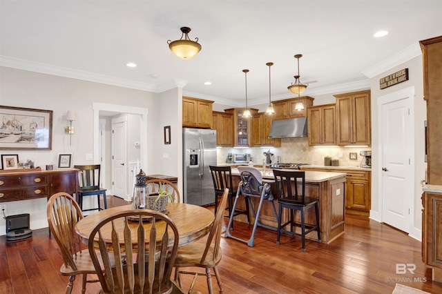 17541 Council Oaks Ln, Bon Secour, AL 36511 - dining space featuring dark wood-style floors, recessed lighting, and ornamental molding
