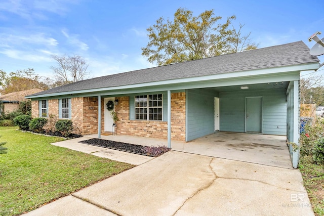 ranch-style house featuring a front yard and a carport