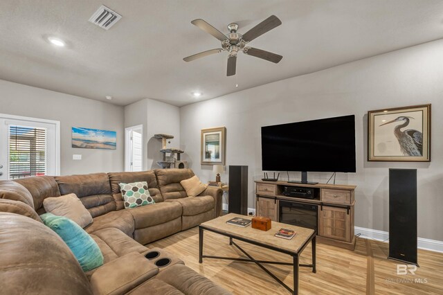 living room with light wood-style floors, ceiling fan, baseboards, and recessed lighting