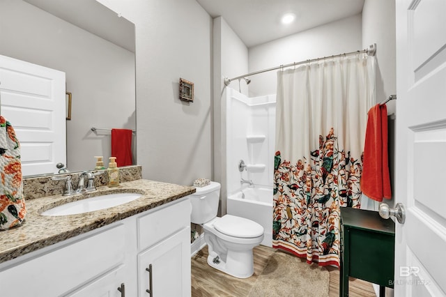 bathroom featuring wood finished floors, vanity, toilet, and shower / tub combo