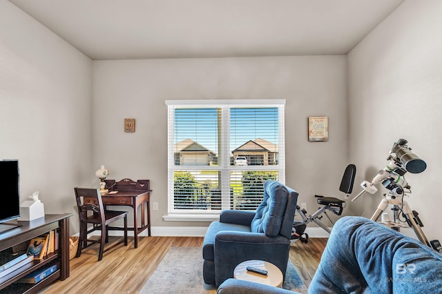 living area with wood finished floors and baseboards