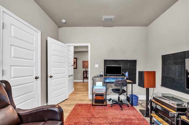 office space with wood finished floors and baseboards