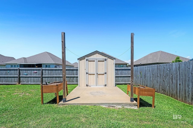 view of yard with a patio area, a shed, and an outbuilding