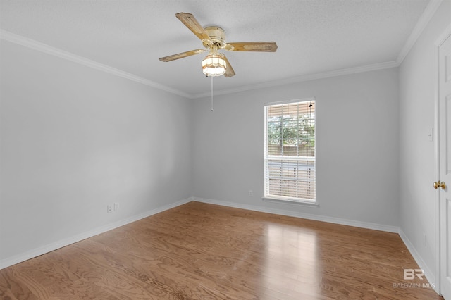 unfurnished room with a ceiling fan, wood finished floors, baseboards, ornamental molding, and a textured ceiling