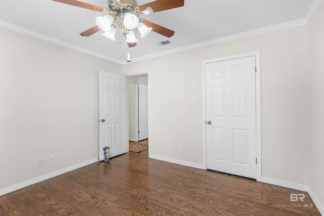 unfurnished bedroom featuring visible vents, baseboards, wood finished floors, and ornamental molding