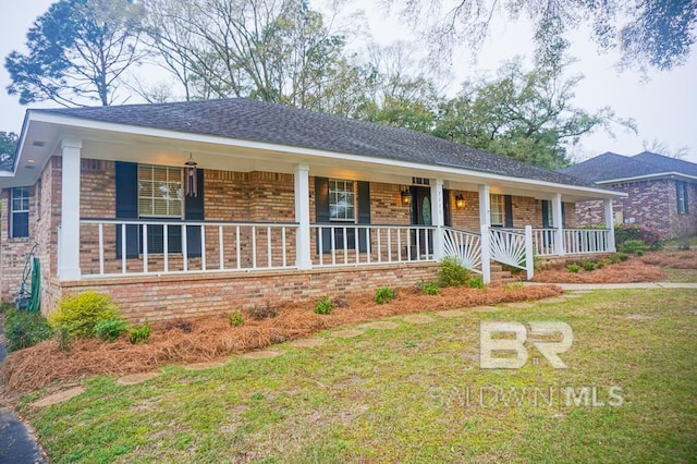 ranch-style home featuring a front lawn, brick siding, and covered porch