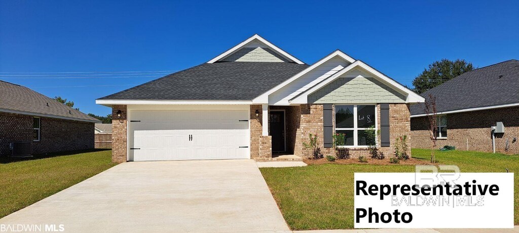 665 Revere St, Foley, AL 36535 - craftsman house featuring a front yard and a garage