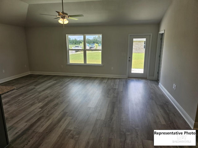 empty room featuring lofted ceiling, ceiling fan, and dark hardwood / wood-style flooring