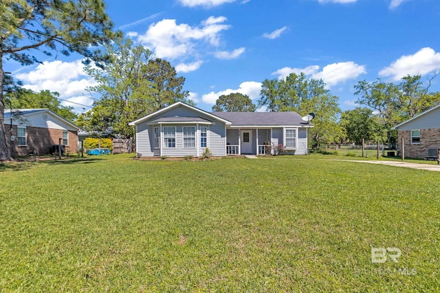 ranch-style home featuring covered porch, a front lawn, and fence