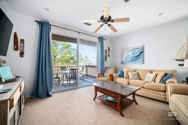 living room featuring ceiling fan, crown molding, and carpet floors