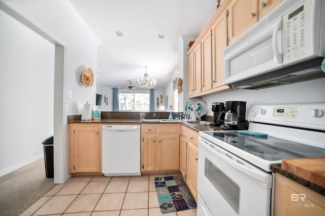 kitchen featuring light carpet, kitchen peninsula, light brown cabinetry, white appliances, and a notable chandelier