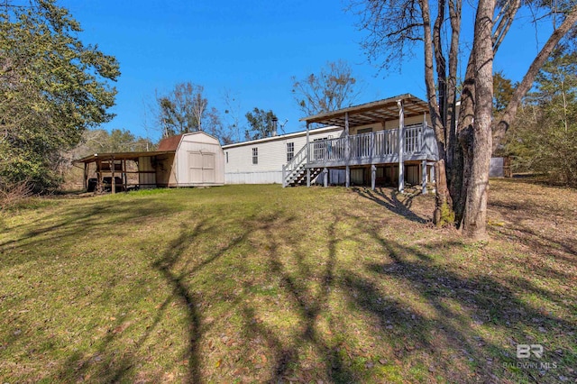 view of yard with a storage shed, a deck, stairway, and an outbuilding